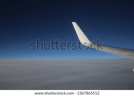 airplane wing in the blue sky