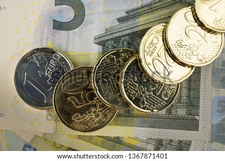 Euro banknotes and coins. Personal finance concept. Macro photo.