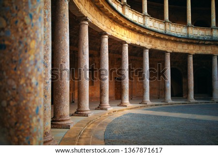 Columns. The Palace of Charles V is a Renaissance building in Granada, southern Spain, located on the top of the hill of the Assabica, inside the Nasrid fortification of the Alhambra. Patio