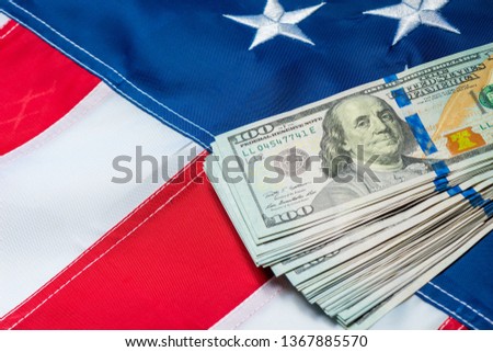 american flag closeup and a bunch of 100 dollar bills