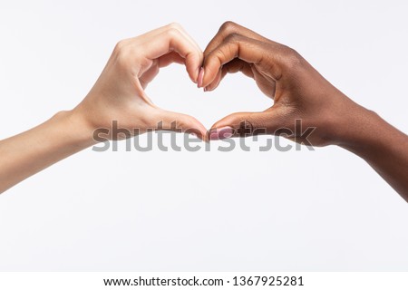 Making heart. Close up of diverse women with different skin color making heart out of hands