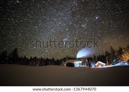Little House on the background of the starry sky in winter. Leave traces in the form of lines