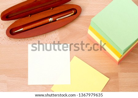 A stack of paper for notes of different colors.