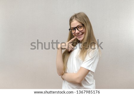 Portrait of a smiling beautiful young girl with glasses. Smart child. Nerdy. Close up