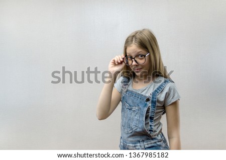 Portrait of a smiling beautiful young girl with glasses. Smart child. Nerdy. Close up