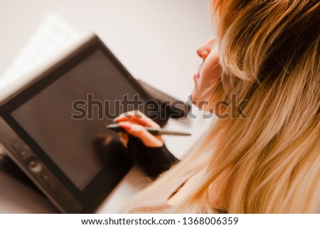 Young hipster graphic woman designer using digital graphics tablet