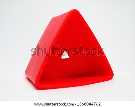 red toy triangle in plastic with white background                            