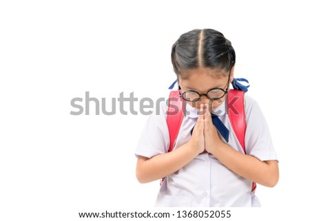 asian child in school uniform and backpack with traditional greeting of Thailand on white background isolated, Sawasdee concept
