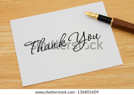 A thank you card with a fountain pen on a wooden desk, Writing a Thank You Note Royalty-Free Stock Photo #136805609