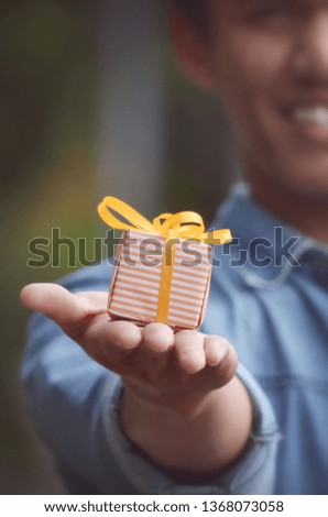 close up of male hands with christmas gift