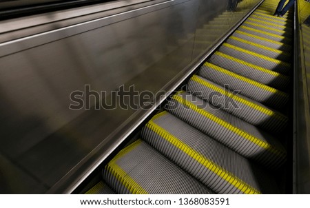 Blurred photo of urban transport.Escalator and reflections,lights and colours.
Subway escalator.