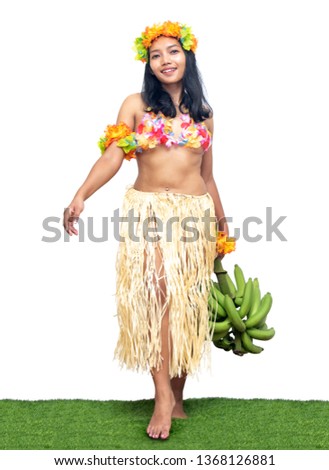 Hawaii Hula Dancer carries bunch of green bananas, isolated on white background. Ethnic women hold fresh tropical fruits.