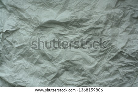 White color crumpled sheet of paper. Abstract background and texture for design.