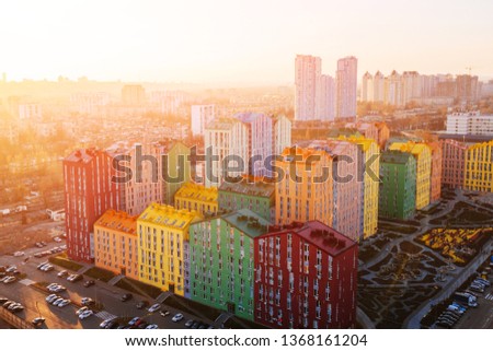 panoramic aerial view of colorful (red, green, blue, yellow) buildings on city street. drone shot