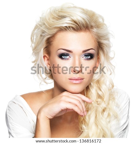 Beautiful blond woman with long curly hair and style makeup. Girl posing on white background Royalty-Free Stock Photo #136816172