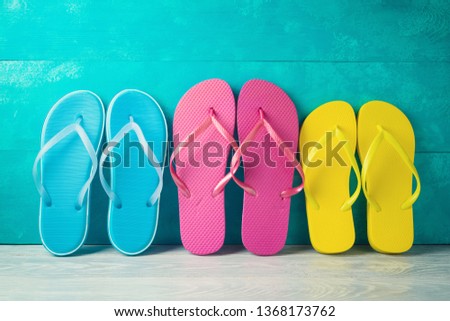Summer concept background with flip flops on wooden table. Family vacation concept