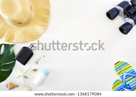 Holiday flat lay binoculars, Straw hat, Tropical leaves tropics, star fish on white background of copy space , summer concept