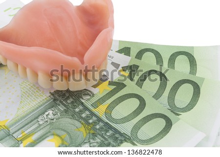 denture and euro bills, symbolic photo for dentures, treatment costs and payment