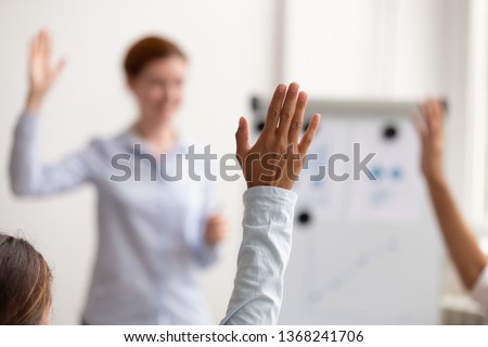 Business team people audience raise hands up ask questions coach engaged in voting at conference concept, volunteers group participate in training presentation corporate seminar, focus on raised hand Royalty-Free Stock Photo #1368241706