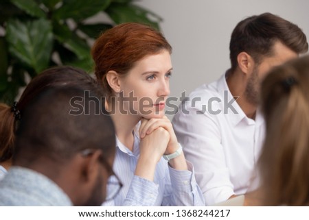 Thoughtful businesswoman thinking of business challenges opportunities at group meeting training, pensive dreamy woman lost in thoughts sit with team at seminar break planning considering new vision Royalty-Free Stock Photo #1368244217