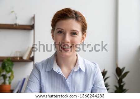 Happy business woman talking by video conference call to virtual distant client having conversation in internet chat looking at camera webcam, smiling hr speaking to webcamera at online job interview Royalty-Free Stock Photo #1368244283