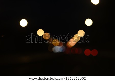 Blur focused urban abstract texture bokeh city lights & traffic jams. Looking out from the windshield of the car cab.