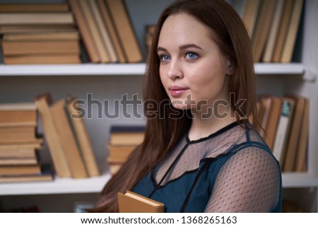 Pretty Female Student Surrounded by Library Books