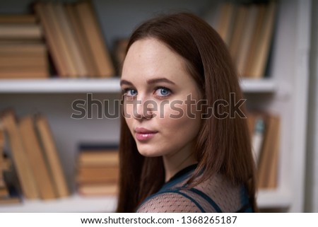 Pretty Female Student Surrounded by Library Books
