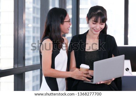 Business people or beautiful lady officer talking or meeting on workplace or desk with computer and window glass city view background