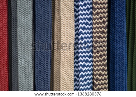 abstract row of woven coloured belts making an unusual background pattern