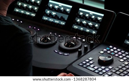 Blurry images of telecine controller machine transferring motion picture film into video and editing or adjusting in a color suite studio lab. which used in the movie post-production process 
