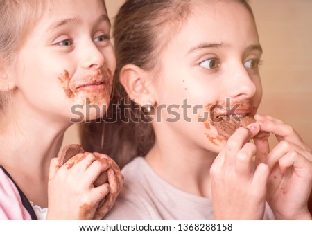 Girl with chocolate.Girls, children eat chocolate, a mouth and hands of girls are smeared with chocolate.