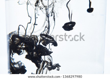 black ink dissolving in water abstract pattern