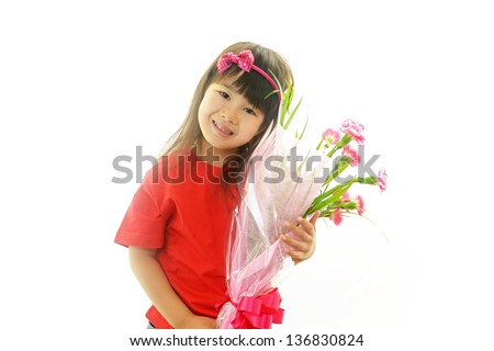 Joyful little girl holding bouquet in hands