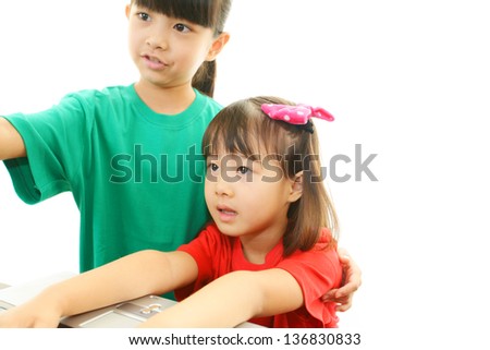 Smiling girls using a laptop