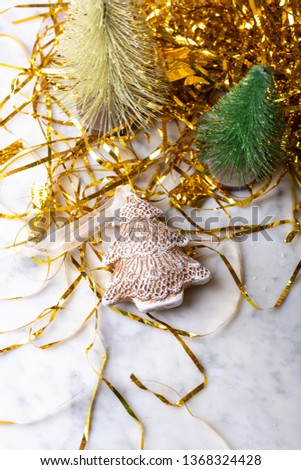 Christmas trees and tinsel on wooden background