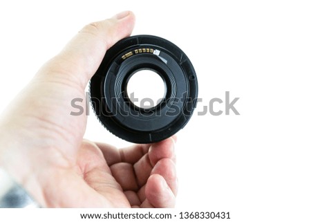 macro lens in male hands visible through the lens isolated background
