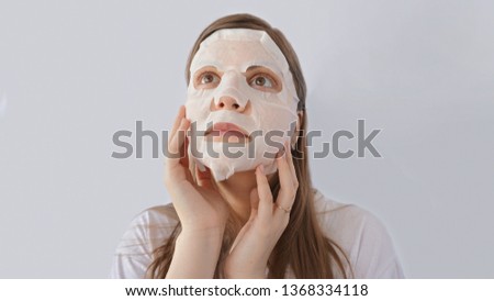 beautiful and cute girl in mask, skin care and moisturizing, with lemon, white background                    