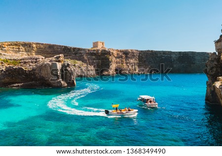 Comino island.  Cliffs, tourist boats and blue sea. Malta country Royalty-Free Stock Photo #1368349490