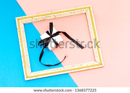 small gift box over frame picture isolated on colorful  background