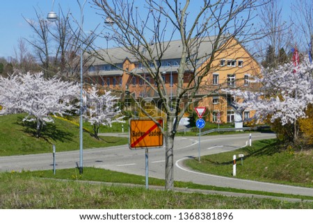 Traffic of a circle in the B500, feeders in Baden-Baden with blossoming trees 
