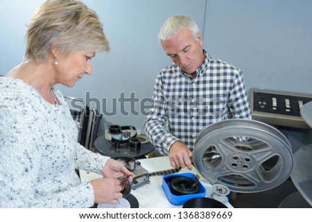 elderly couple with home film reels
