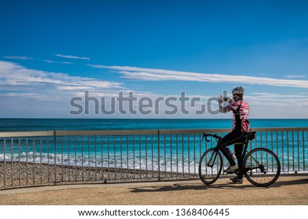 Cyclist takes a picture at Menton, France