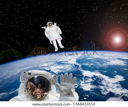 Astronauts flying in outer space. Space scene. The elements of this image furnished by NASA.
