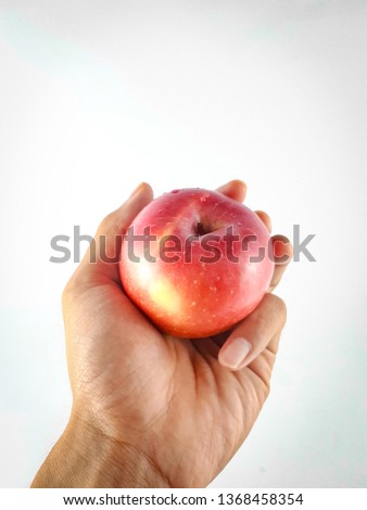 Hands holding apple in a white background