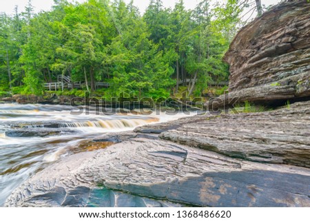 Beautiful waterfall at Porcupine Mountains Wilderness State Park in the Upper Peninsula of Michigan - smooth tranquil flowing water