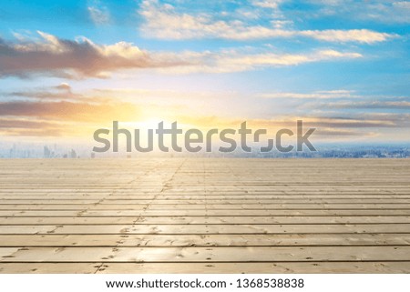 Shanghai city skyline and wooden platform with beautiful clouds scenery at sunset