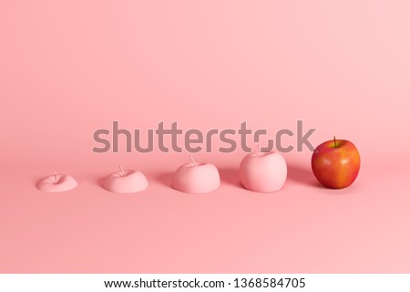 Outstanding fresh red apple and slices of apple painted in pink on pink background. Minimal fruit idea concept.