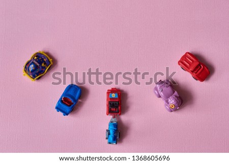 Cars toys on pink background. Top view
