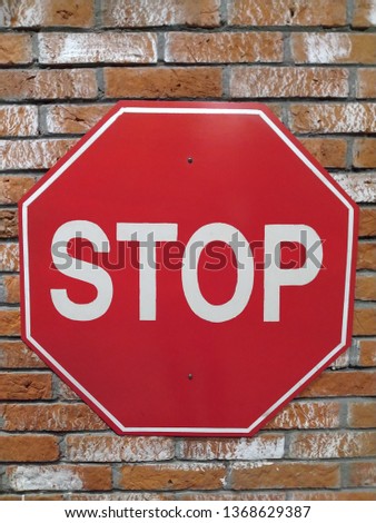 Stop traffic signs on the brick wall.